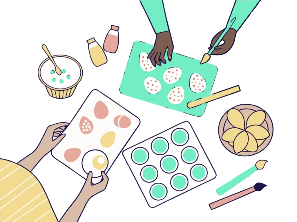 Vue de dessus d'un atelier créatif de Pâques avec des mains d'enfants décorant des œufs et des cupcakes